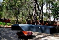 Contemporary screens behind seating with firepit